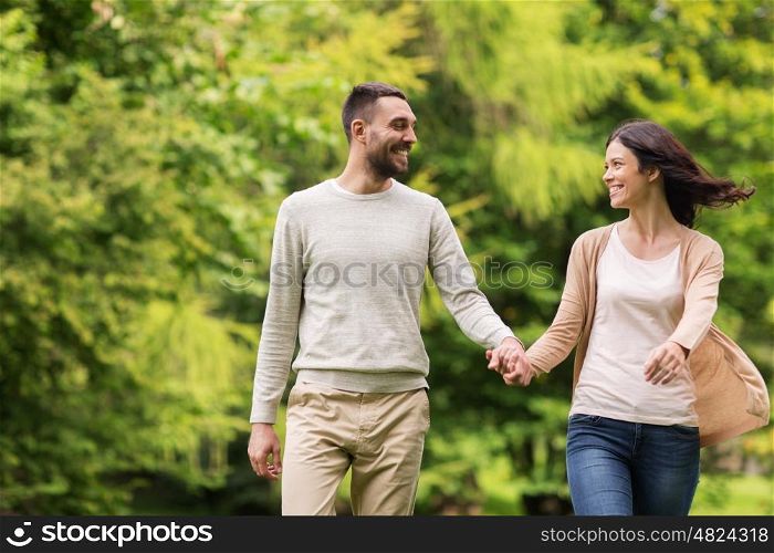 love, relationship, family and people concept - happy couple walking in summer park