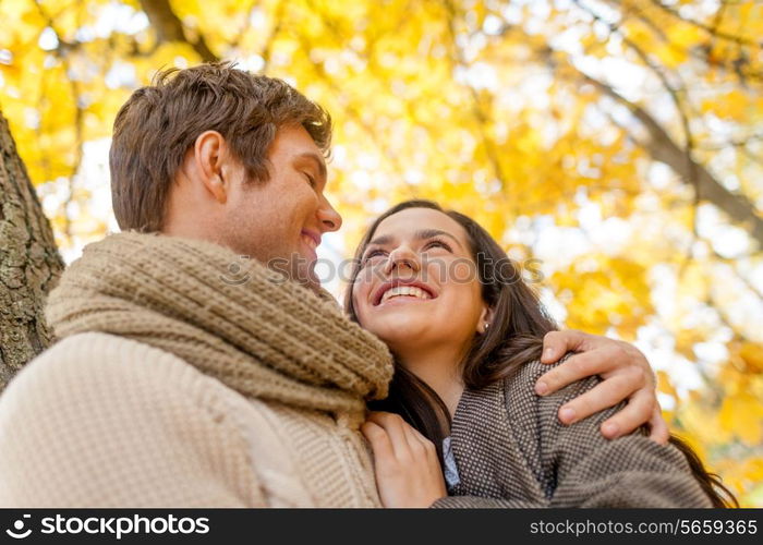 love, relationship, family and people concept - smiling couple hugging in autumn park