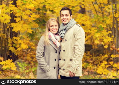 love, relationship, family and people concept - smiling couple hugging in autumn park