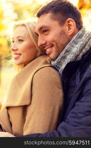 love, relationship, family and people concept - smiling couple hugging in autumn park