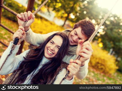 love, relationship, family and people concept - smiling couple hugging in autumn park