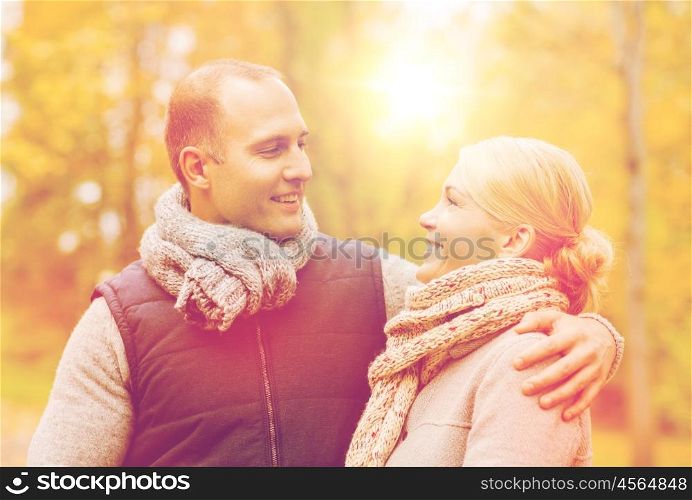 love, relationship, family and people concept - smiling couple in autumn park