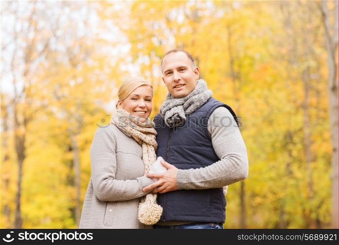 love, relationship, family and people concept - smiling couple in autumn park