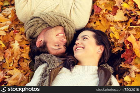 love, relationship, season, family and people concept - close up of smiling couple lying in autumn park