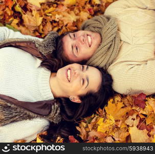 love, relationship, season, family and people concept - close up of smiling couple lying in autumn park