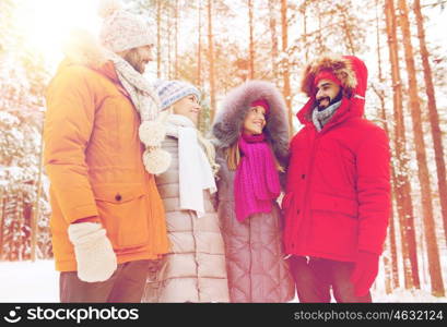 love, relationship, season, friendship and people concept - group of smiling men and women talking in winter forest