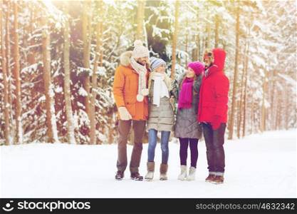 love, relationship, season, friendship and people concept - group of smiling men and women talking in winter forest