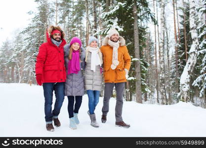 love, relationship, season, friendship and people concept - group of smiling men and women walking in winter forest