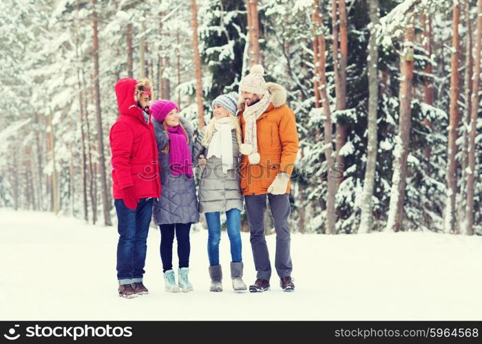 love, relationship, season, friendship and people concept - group of smiling men and women talking in winter forest