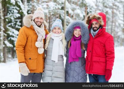 love, relationship, season, friendship and people concept - group of smiling men and women walking in winter forest