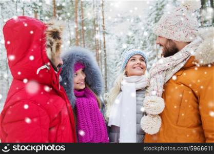 love, relationship, season, friendship and people concept - group of smiling men and women talking in winter forest. group of smiling men and women in winter forest