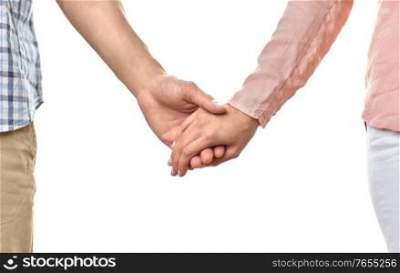 love, relationships and people concept - close up of happy couple holding hands at home. close up of happy couple holding hands at home