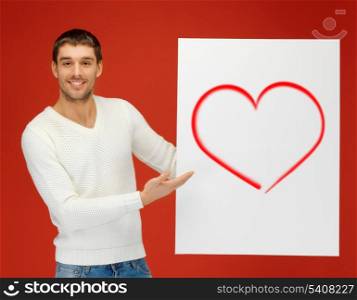 love, relationships, holidays and valentine&#39;s day cancept - handsome man holding big board with heart