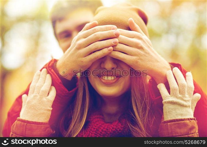 love, relationships, season and people concept - happy young couple having fun in autumn park. happy young couple having fun in autumn park