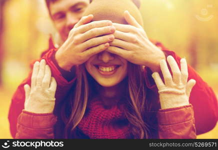 love, relationships, season and people concept - happy young couple having fun in autumn park. happy young couple having fun in autumn park