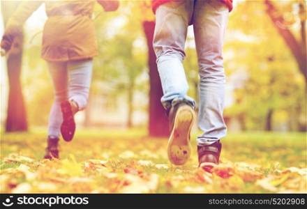 love, relationships, season and people concept - young couple running in autumn park. young couple running in autumn park