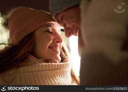 love, romance and people concept - close up of happy couple in winter clothes. close up of happy couple in winter clothes