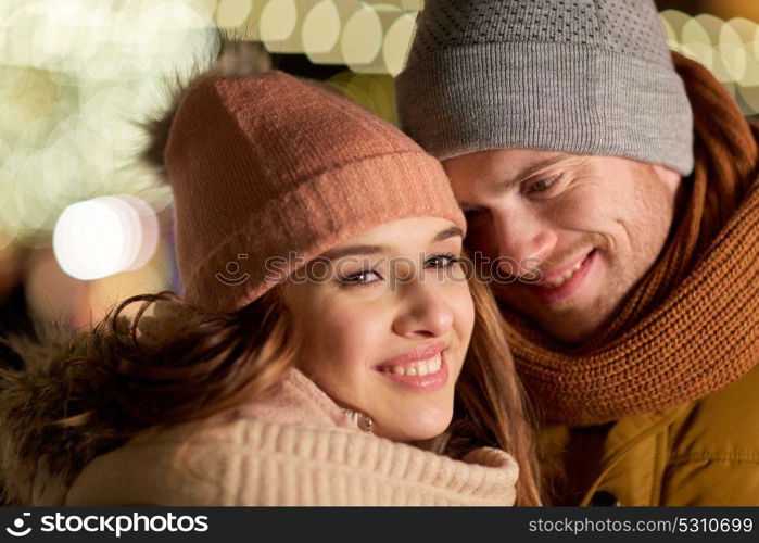 love, romance and people concept - close up of happy couple in winter clothes. close up of happy couple in winter clothes