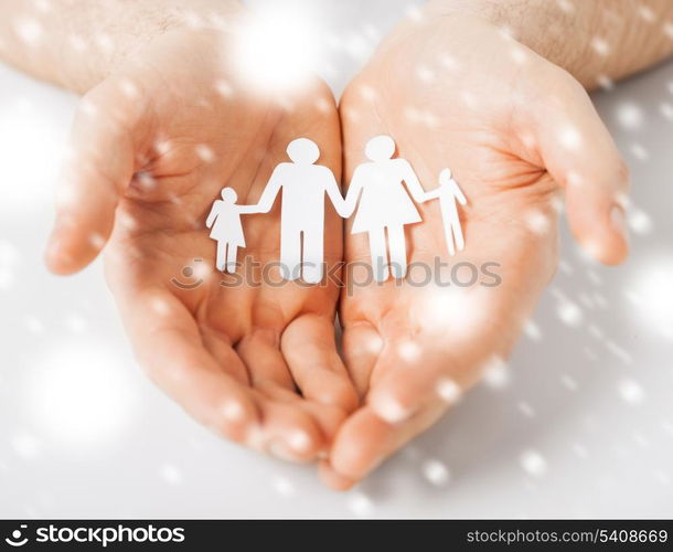 love, romance, safety concept - man hands showing family of paper people