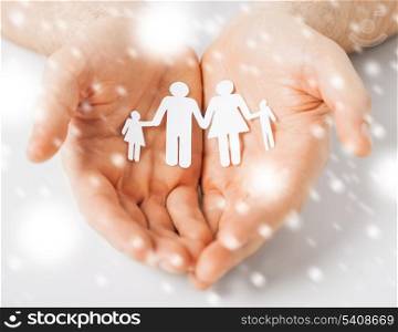 love, romance, safety concept - man hands showing family of paper people