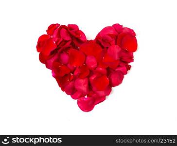 love, romance, valentines day and holidays concept - close up of red rose petals in heart shape