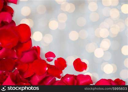 love, romance, valentines day and holidays concept - close up of red rose petals with copyspace over lights background