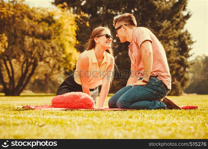 Love romance valentines relationship dating concept. Cheerful affectionate couple on picnic. Young lady and her man spend time together in park. . Cheerful affectionate couple on picnic.