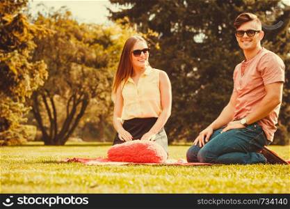 Love romance valentines relationship dating concept. Cheerful affectionate couple on picnic. Young lady and her man spend time together in park. . Cheerful affectionate couple on picnic.