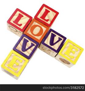 Love spelt with alphabe blocks in criss-cross style.