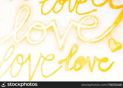 Love Sprayed on Wall with Gold Paint