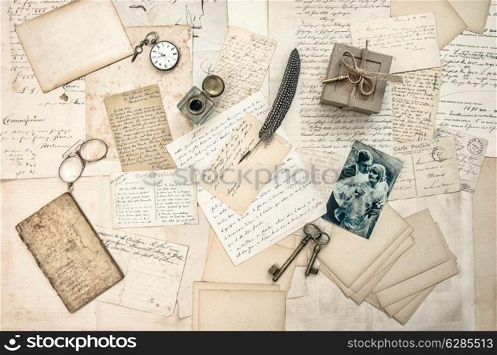 love story. old letters, vintage postcards and antique feather pen. nostalgic sentimental background with retro picture of couple