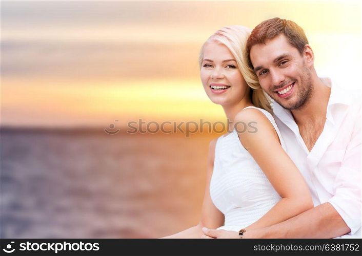 love, summer holidays, relationships and people concept - happy couple hugging over sea background. happy couple hugging over sea background