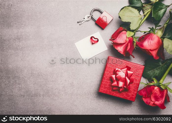 Love symbols concept. Red gift box, ribbon, roses bunch , blank white paper card and heart, lock and key, top view. Mock up for greeting for Mothers day,birthday or Valentine?s Day