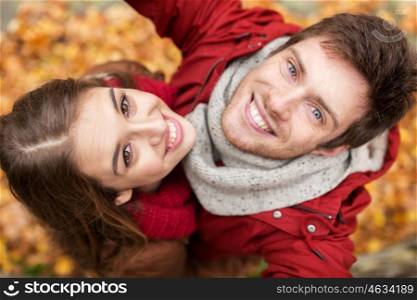 love, technology, relationship, family and people concept - close up of happy smiling young couple taking selfie in autumn park