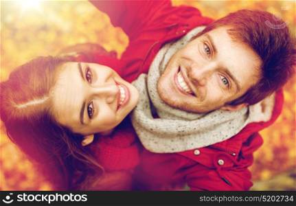 love, technology, relationship, family and people concept - close up of happy smiling young couple taking selfie in autumn park. close up of happy couple taking selfie at autumn