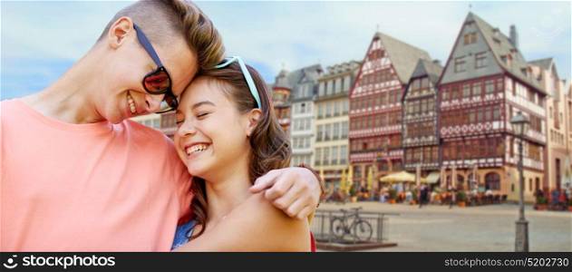 love, travel, tourism and people concept - happy smiling teenage couple hugging over frankfurt am main city background. happy teenage couple hugging in frankfurt city