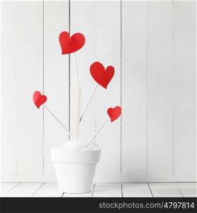 Love tree in flower pot. Love tree with red heart shaped leaves in white flower pot