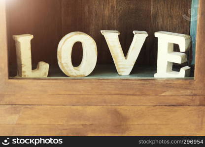 Love, valentine and wedding background concept. ?LOVE? wood character on wood wall cabinet. Picture for add text message. Backdrop for design art work.