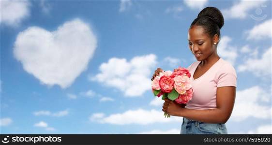 love, valentine&rsquo;s day and people concept - happy african american young woman with bunch of peony flowers over grey background. happy african american woman with bunch of flowers