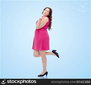 love, valentines day and people concept - happy young plus size woman posing in pink dress and sending blow kiss over blue background