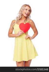 love, valentines day and people concept - smiling young woman in dress with red paper heart. happy young woman with red paper heart