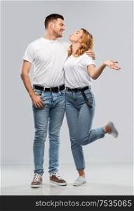 love, valentines day and relationships concept - portrait of happy couple in white t-shirts ready for kiss over grey background. couple in white t-shirts ready for kiss