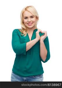 love, valentines day, gesture, plus size and people concept - smiling young woman in shirt and jeans showing heart shape hand sign