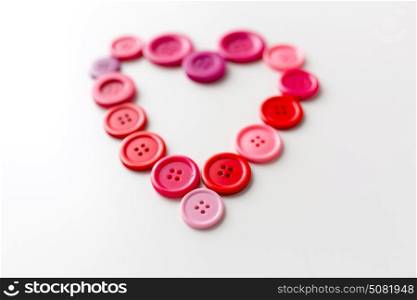 love, valentines day, needlework and tailoring concept - heart shape of sewing buttons. heart shape of sewing buttons