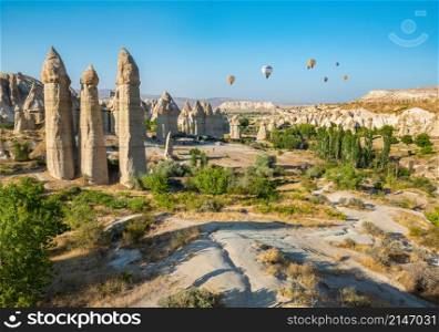Love valley in Goreme national park. Cappadocia, Turkey. Air balloons over valley of love