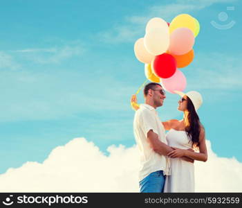 love, wedding, summer, dating and people concept - smiling couple wearing sunglasses with balloons hugging over blue sky and cloud background