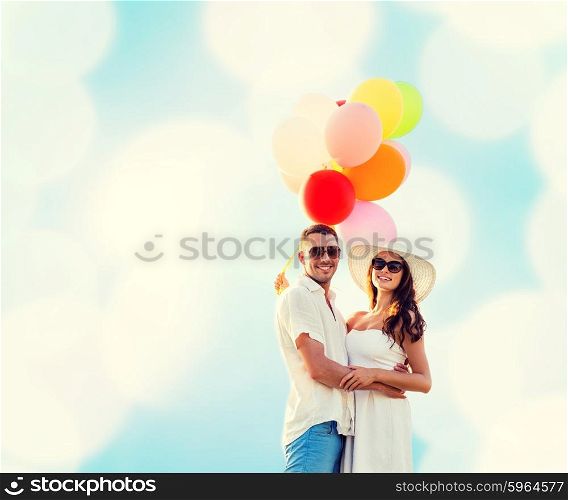 love, wedding, summer, dating and people concept - smiling couple wearing sunglasses with balloons hugging over blue lights background