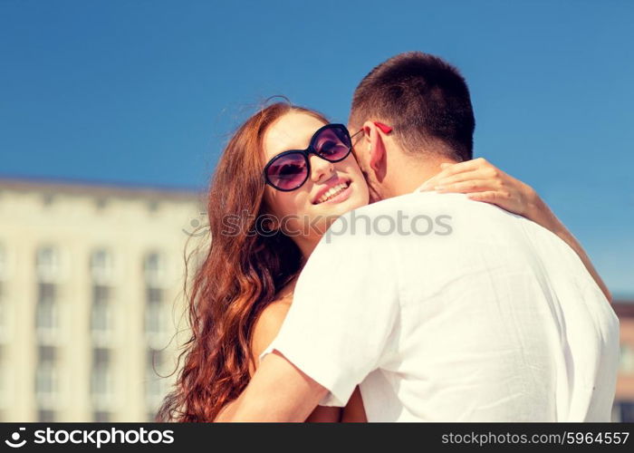 love, wedding, summer, dating and people concept - smiling couple wearing sunglasses hugging in city