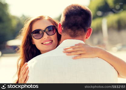 love, wedding, summer, dating and people concept - smiling couple wearing sunglasses hugging in park