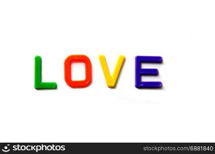 love with colorful plastic alphabets on white background.